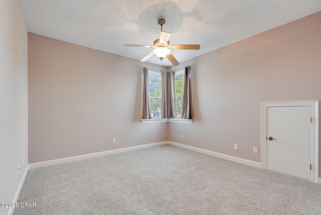 spare room featuring ceiling fan, a textured ceiling, baseboards, and carpet flooring