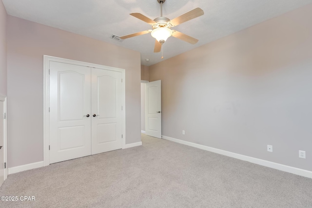 unfurnished bedroom featuring visible vents, baseboards, ceiling fan, carpet floors, and a closet