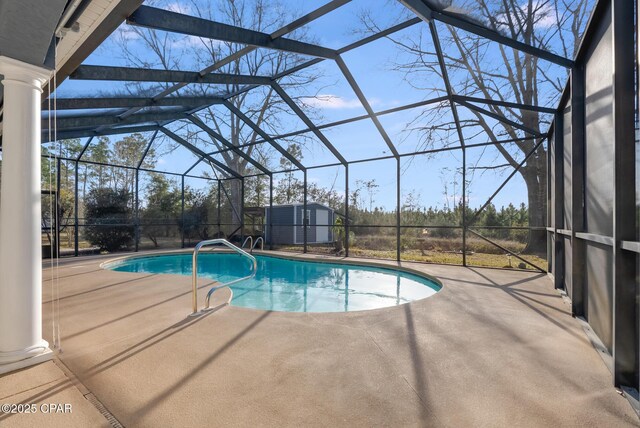 pool with glass enclosure, a storage unit, an outdoor structure, and a patio