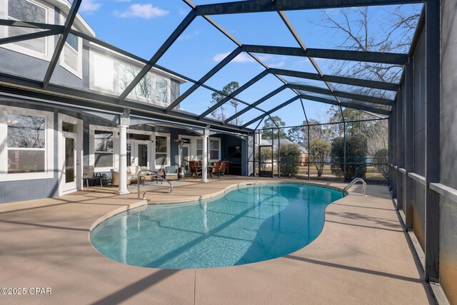 outdoor pool with a lanai and a patio