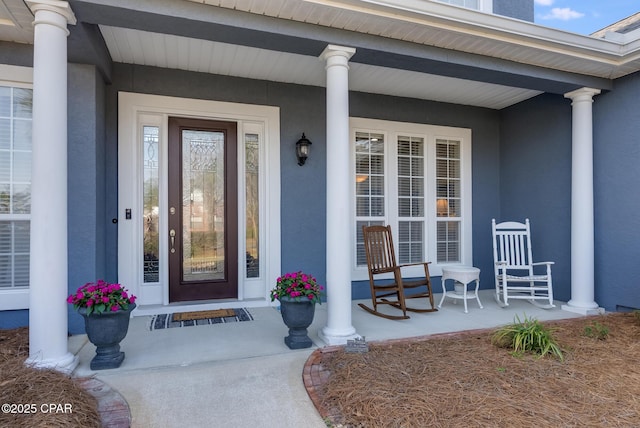 233 Moonlight Bay Dr, Panama City Beach, FL 32407 - doorway to property with a porch and stucco siding