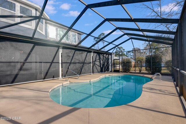 pool with a lanai and a patio