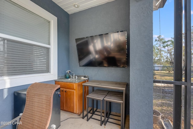 interior space featuring concrete flooring and a sink