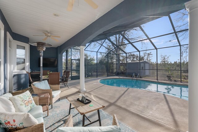 outdoor pool featuring decorative columns and ceiling fan