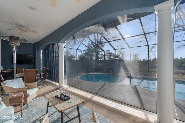 sunroom with a ceiling fan, plenty of natural light, and ornate columns