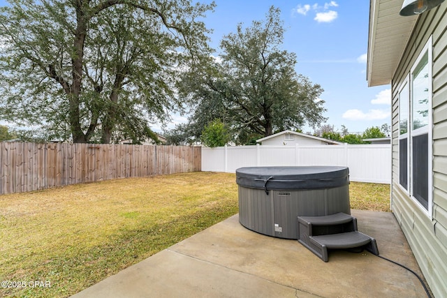 view of patio with a fenced backyard and a hot tub