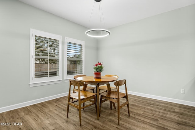 dining room featuring baseboards and wood finished floors