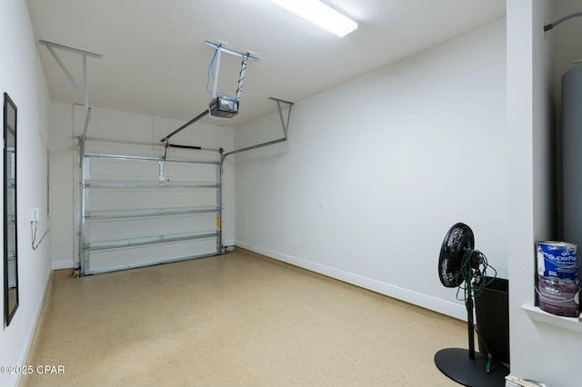 garage with baseboards and a garage door opener