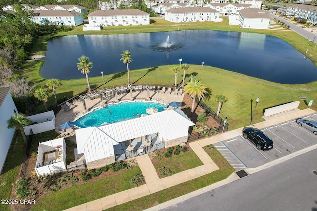 drone / aerial view with a residential view and a water view