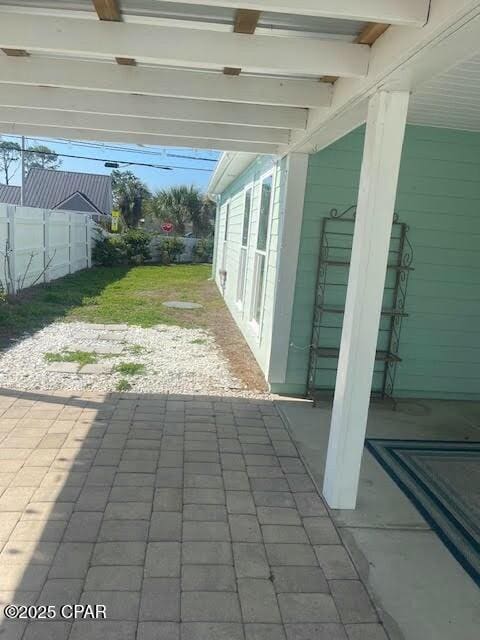 view of patio featuring fence