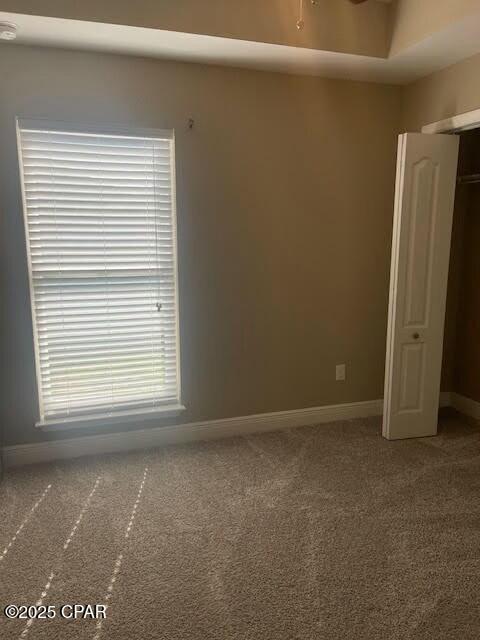 carpeted spare room with baseboards