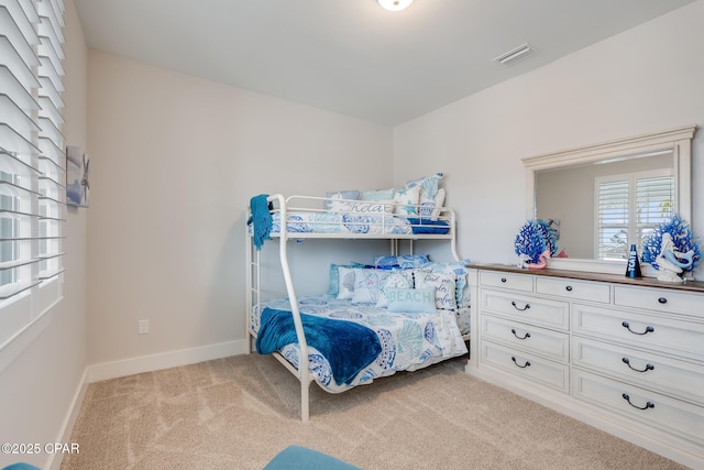 bedroom featuring carpet, visible vents, and baseboards