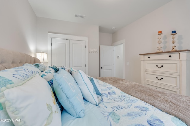 bedroom featuring visible vents and a closet