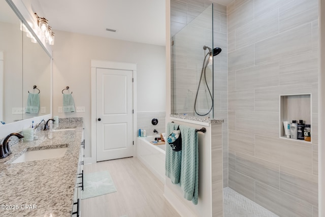 full bathroom with walk in shower, a sink, and a bath