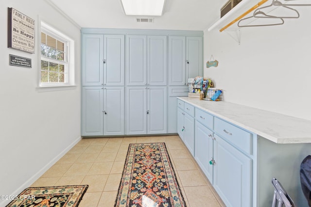 3368 Bevia Rd, Marianna, FL 32446 - washroom featuring light tile patterned floors, baseboards, and cabinet space