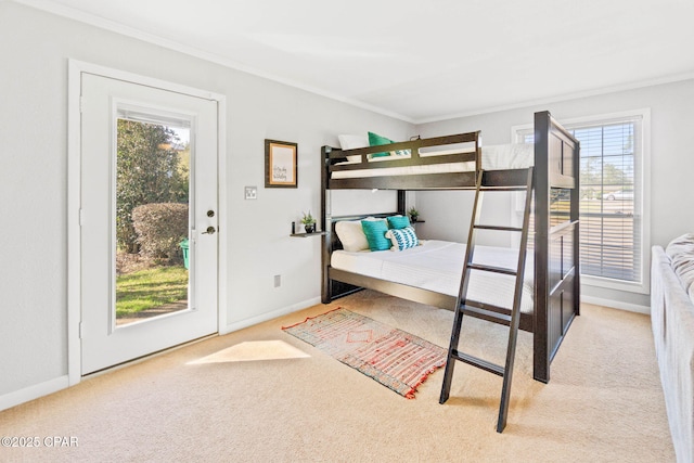 bedroom with ornamental molding, carpet flooring, and baseboards