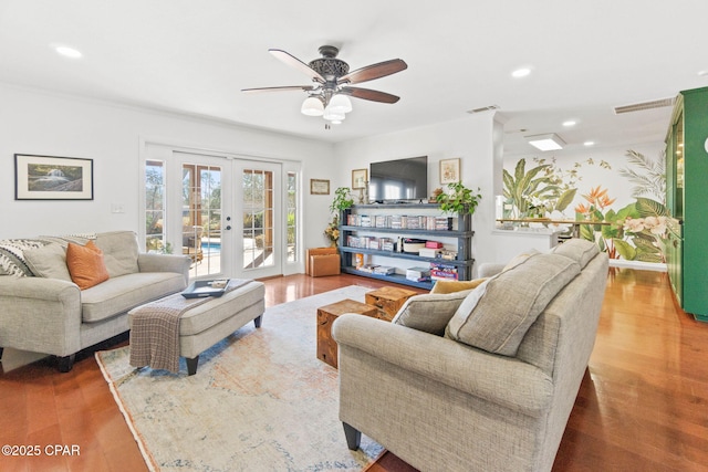 living area with french doors, recessed lighting, visible vents, ceiling fan, and wood finished floors