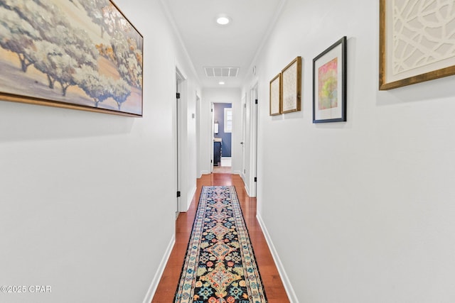 corridor featuring recessed lighting, visible vents, ornamental molding, wood finished floors, and baseboards