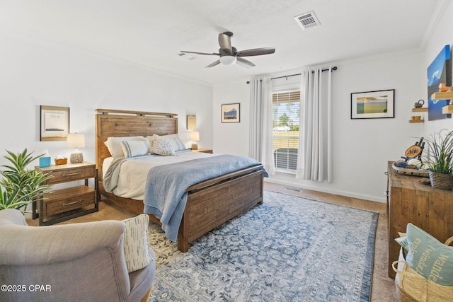 carpeted bedroom featuring visible vents, crown molding, baseboards, and ceiling fan