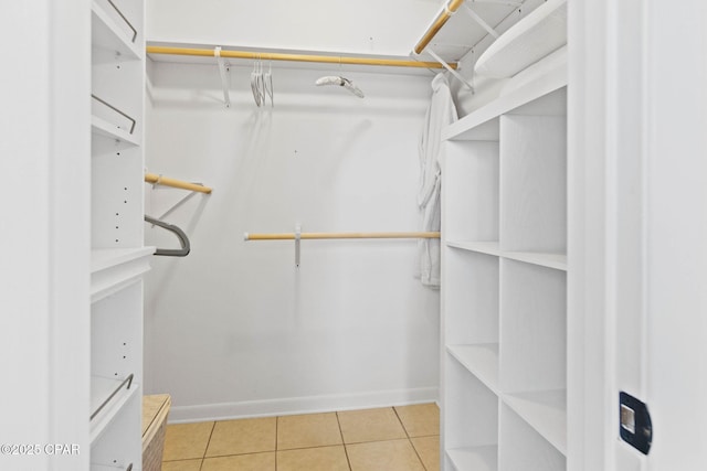 walk in closet featuring tile patterned flooring