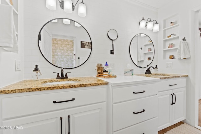 bathroom with double vanity, ornamental molding, a sink, and decorative backsplash