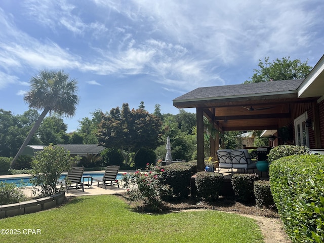 3368 Bevia Rd, Marianna, FL 32446 - view of green lawn featuring ceiling fan, a patio, and an outdoor pool
