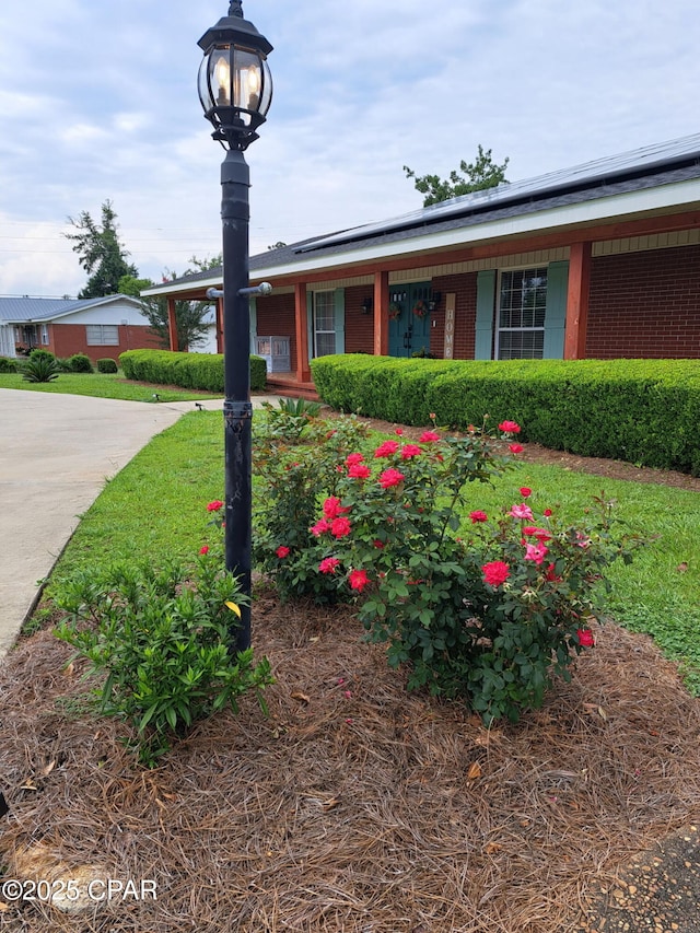 3368 Bevia Rd, Marianna, FL 32446 - ranch-style home with solar panels and brick siding