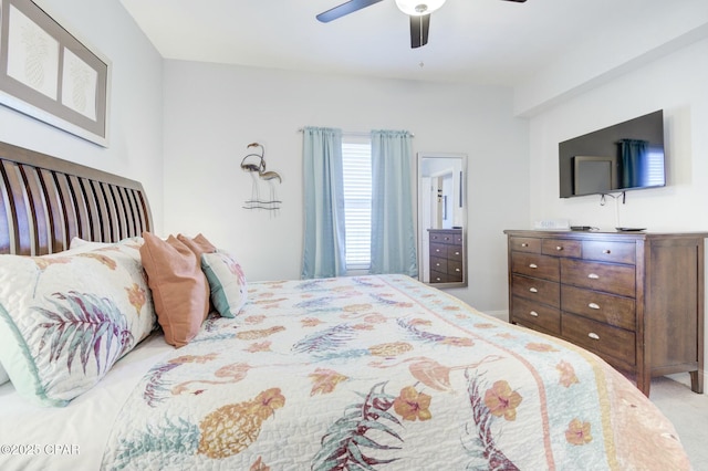 bedroom featuring ceiling fan and light carpet