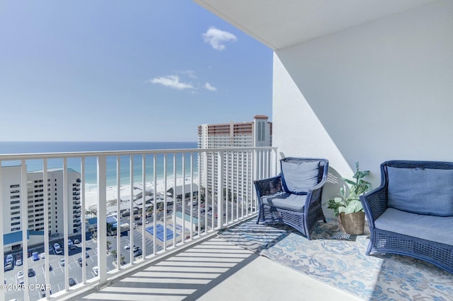 balcony with a water view and a beach view