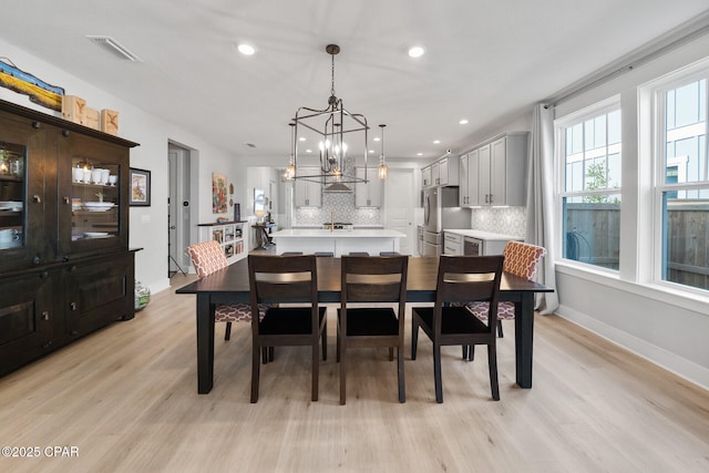 dining space featuring light wood-style floors, visible vents, a chandelier, and recessed lighting