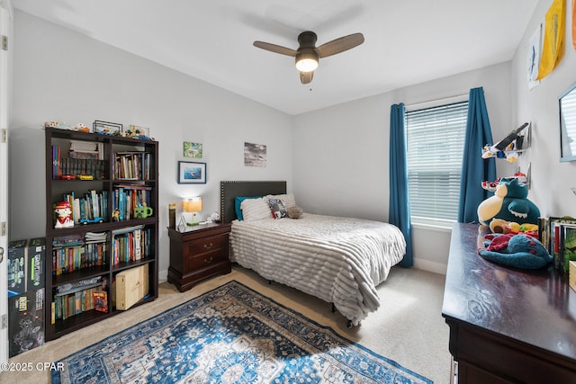 bedroom featuring baseboards, a ceiling fan, and carpet flooring