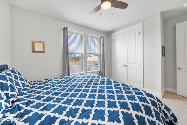 bedroom featuring carpet floors, a closet, baseboards, and a ceiling fan