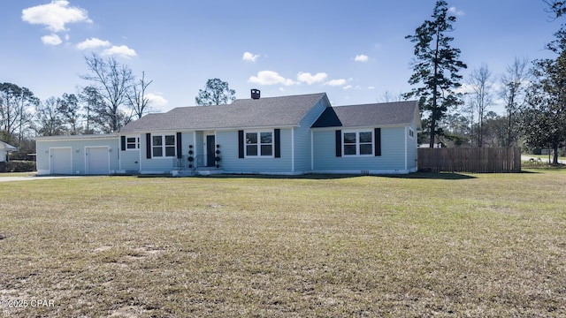 ranch-style home with a front yard, fence, and an attached garage