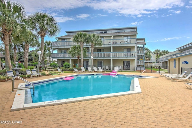 community pool featuring a patio area and fence