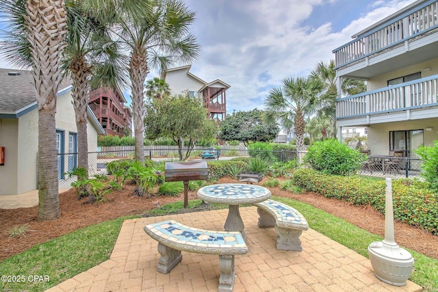 view of community with a patio area and fence