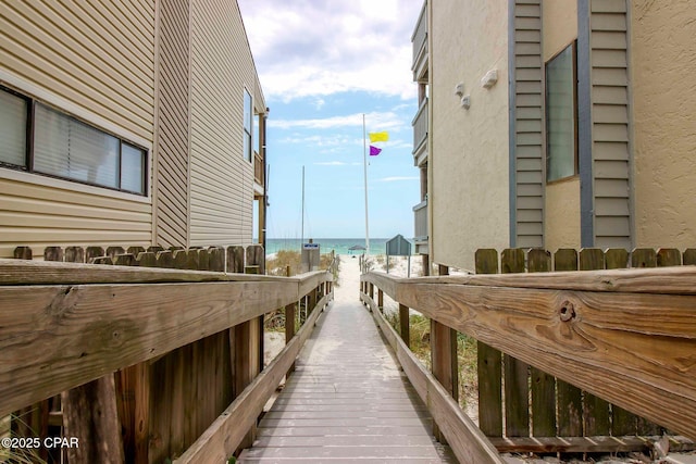 surrounding community featuring a water view and a view of the beach