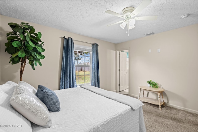 bedroom featuring a textured ceiling, carpet, visible vents, and baseboards