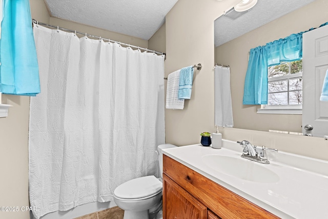 full bathroom with a textured ceiling, toilet, and vanity