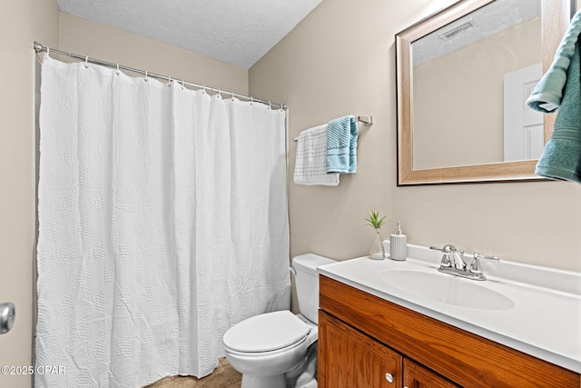 bathroom with a textured ceiling, toilet, and vanity