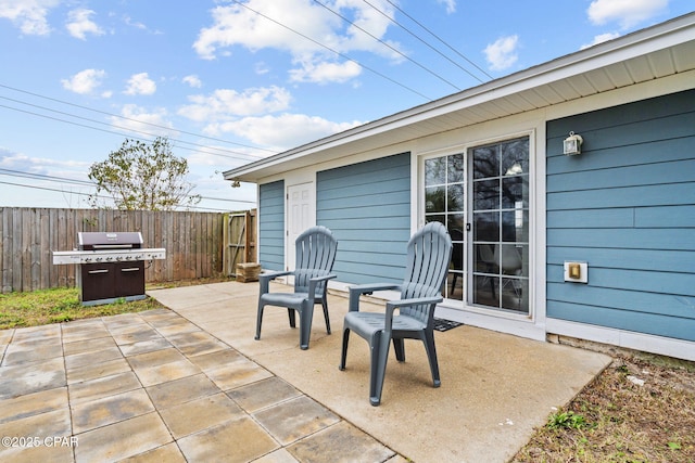 view of patio / terrace with grilling area and fence