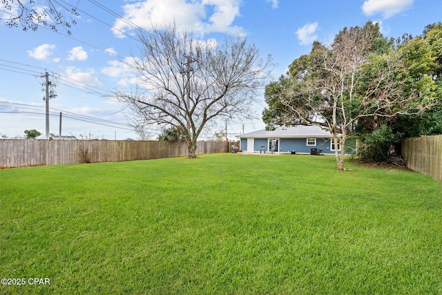 view of yard with a fenced backyard