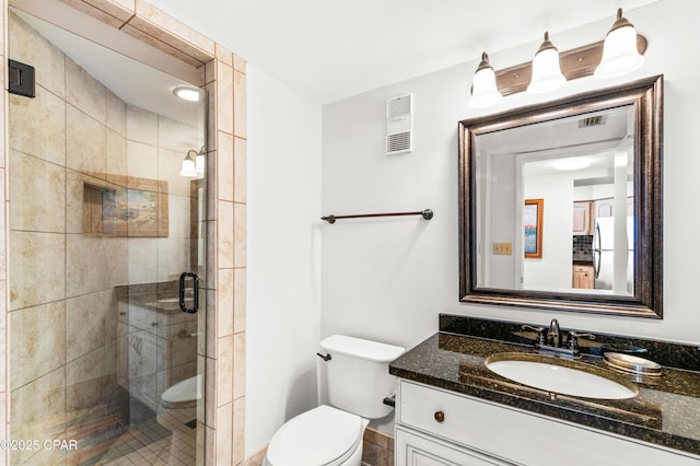 bathroom with toilet, a shower stall, visible vents, and vanity