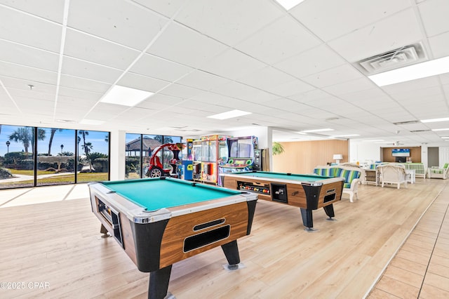 game room with light wood finished floors, billiards, visible vents, a drop ceiling, and floor to ceiling windows