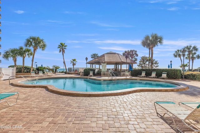 pool featuring a patio area, fence, and a gazebo