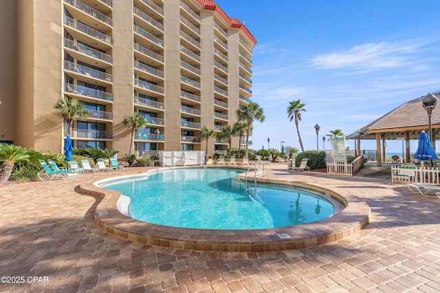 pool featuring a patio and a gazebo