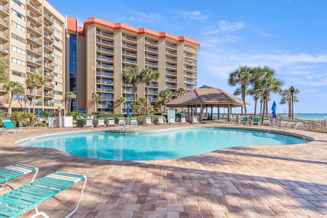 community pool with a patio and a gazebo