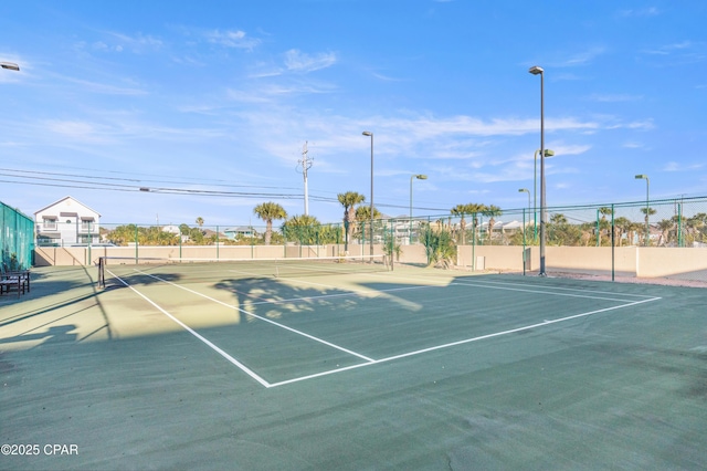 view of tennis court with fence