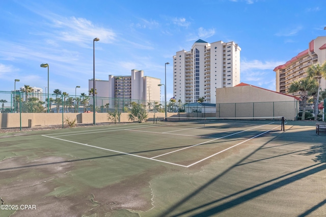 view of sport court featuring fence