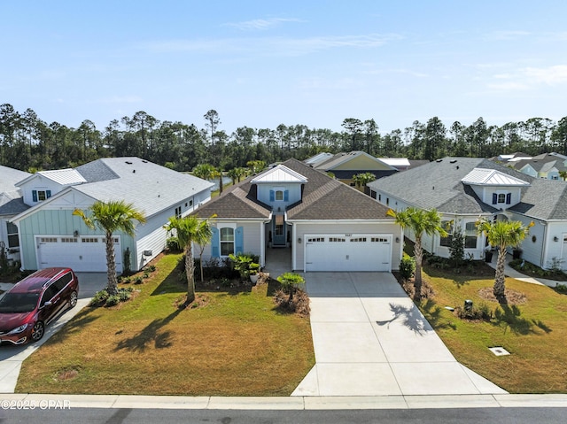 view of front of house featuring board and batten siding, a residential view, concrete driveway, a front yard, and a garage