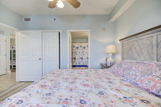 bedroom featuring ceiling fan, visible vents, a closet, and wood finished floors